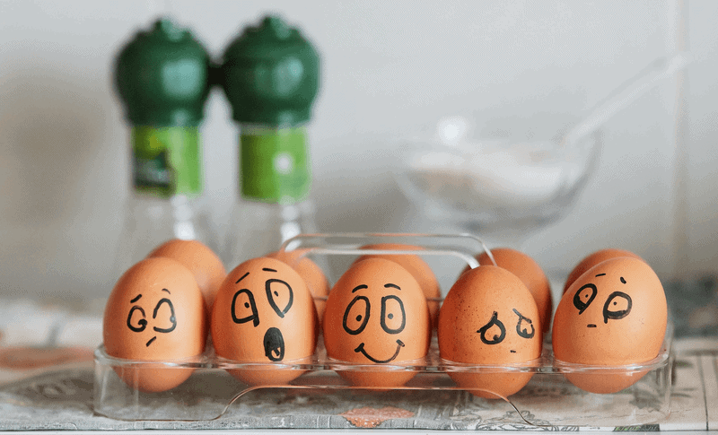 Painted eggs expressing a range of emotions from joy to depression.