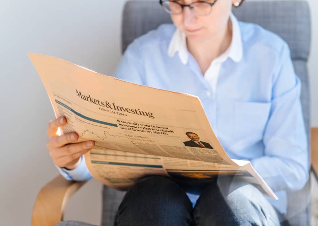 Women reading an investment newspaper.